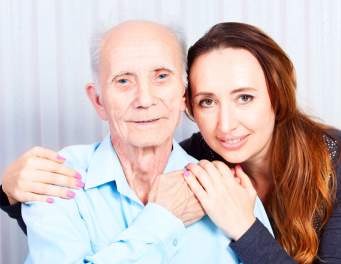 Elderly man hugging granddaughter